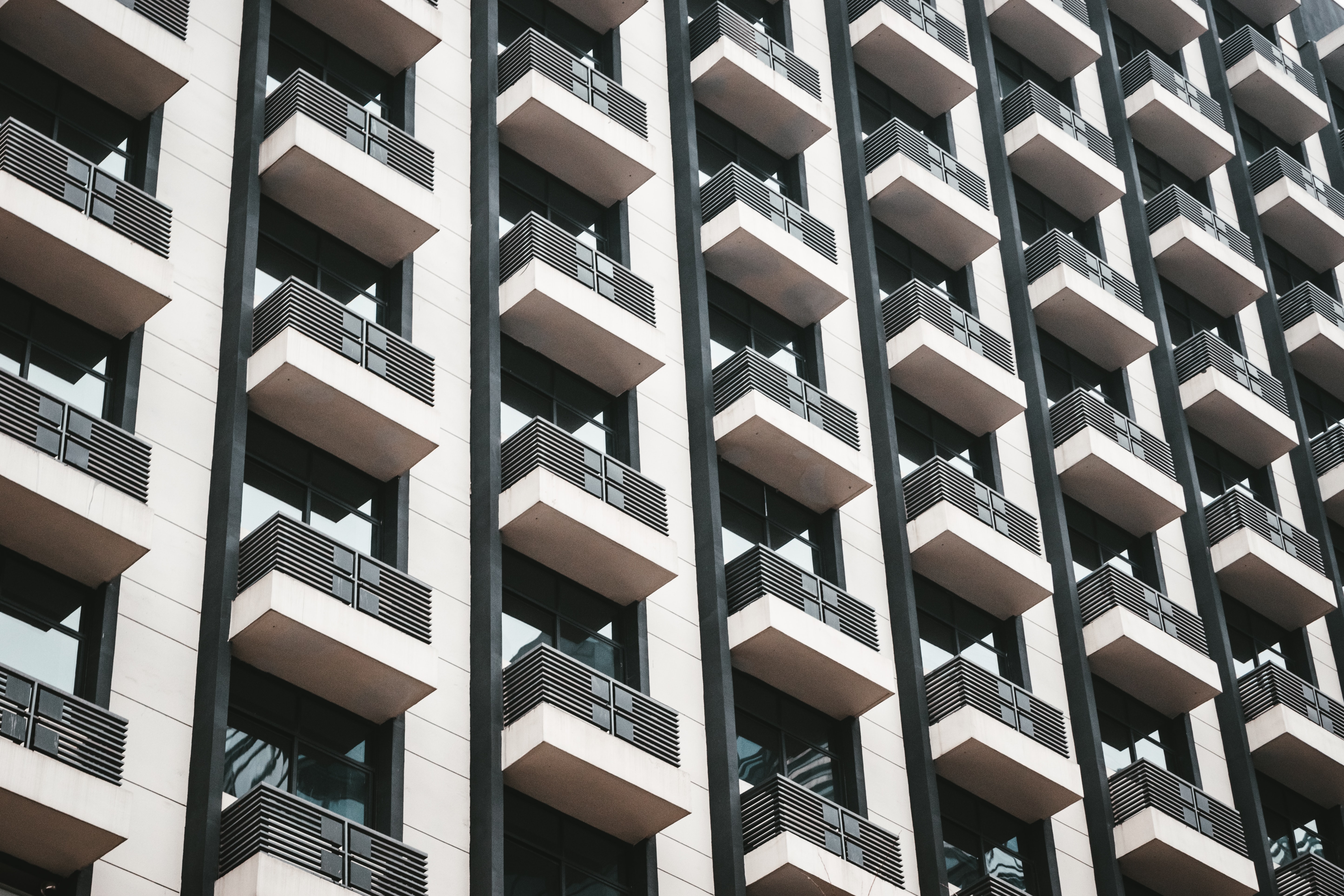 Looking up at vertically aligned balconies.